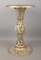 An ornate pierced brass side table, on circular base. Height: 48cm.