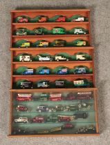 A collection of diecast vehicles in three separate display cases, mostly Lledo Days Gone examples.