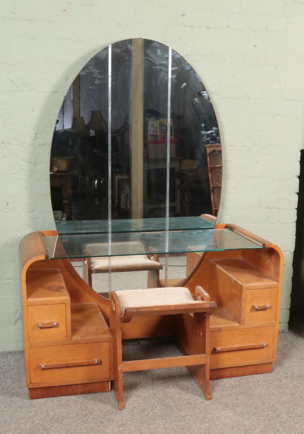An Art Deco style G Plan E Gomme oak mirrored dressing table, with glass shelf and three piece large