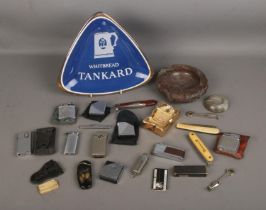 A collection of vintage lighters and penknives with novelty ashtrays including Benson and Hedges and