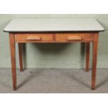 A 1930's oak desk with two drawers under a Formica top. Hx77cm Wx144cm Dx75cm