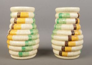 A pair of Clarice Cliff vases in the 'Raffia' pattern. Bearing factory stamps and 722 to the base.