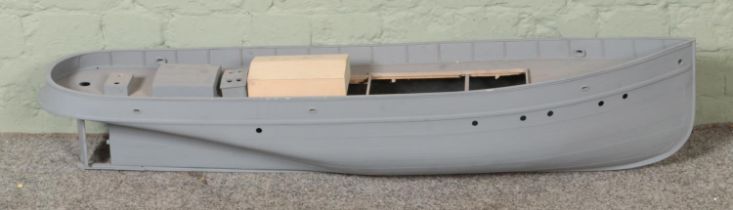 A composite model boat hull with upper deck and partially built balsa wood cabin. Approx. boat