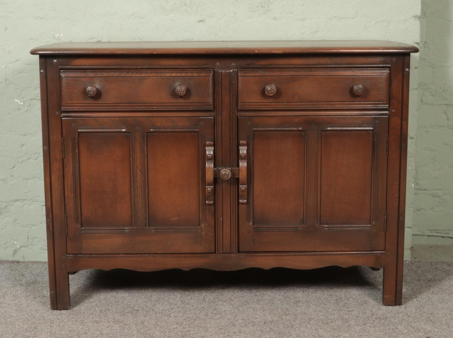 A dark Ercol Old Colonial sideboard.