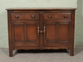 A dark Ercol Old Colonial sideboard.