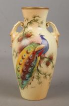 A Locke & Co Worcester hand painted vase, decorated with a peacock. Signed H Wall. 19cm.