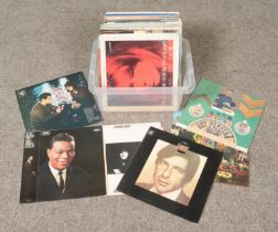 A box of LP records. Includes Beatles Sgt Peppers Lonely Heart Club Band, Paul Simon, Leonard