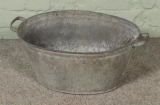 A small galvanised tin bath tub. Approx. dimensions 57cm x 41cm.