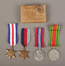 A set of four WWII medals with ribbons in original box, awarded to J.M Foster, Royal Army Service