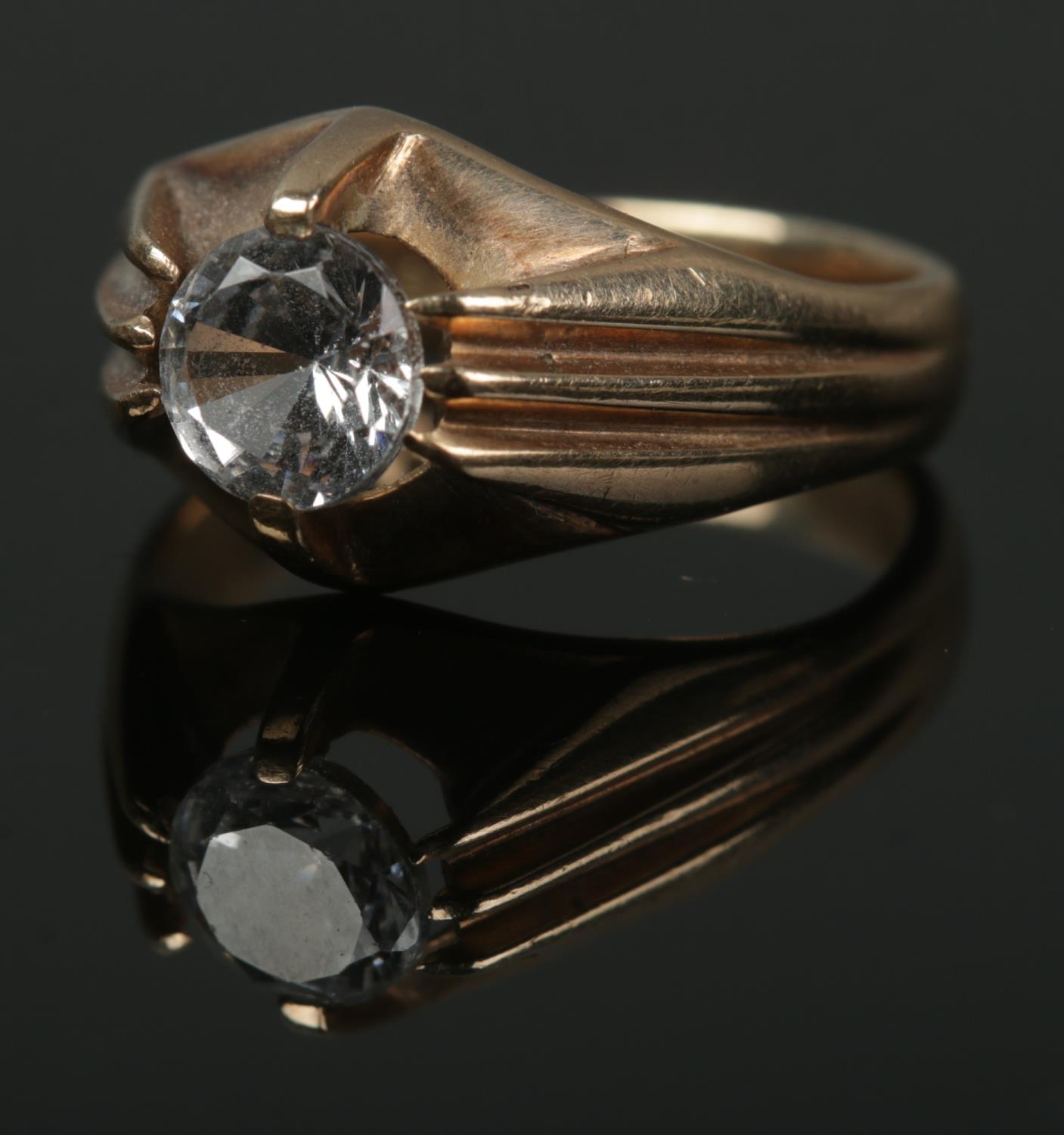 A 9ct gold ring set with single clear paste stone. Size K, total weight 3.8g.