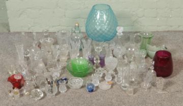 A large quantity of glassware including cut glass decanters, large blue glass centrepiece, cut glass