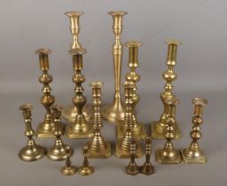 A large quantity of brass candlesticks mostly containing pairs.