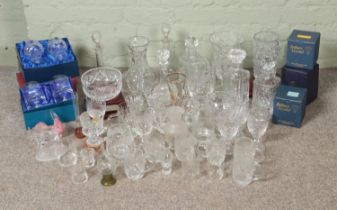 A large quantity of cut glass including decanters, vases, bowls, trophy glass. Some still in