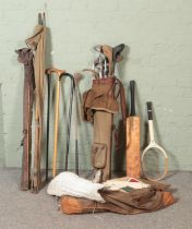 A large quantity of vintage sporting equipment including gold clubs and bag, cricket bat and kit,
