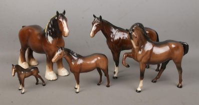 Four Beswick ceramic horses, together with a similar Royal Doulton example. Includes large Shire