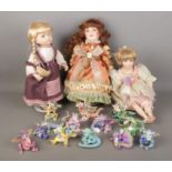 A collection of boxed Mood Dragons together with three porcelain dolls including examples from the