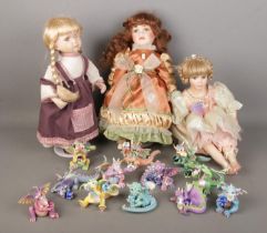 A collection of boxed Mood Dragons together with three porcelain dolls including examples from the