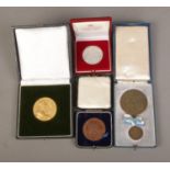 A collection of cased commemorative medals to include bronze Bavaria 25th Anniversary, sterling