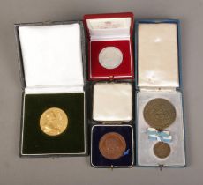 A collection of cased commemorative medals to include bronze Bavaria 25th Anniversary, sterling