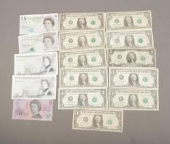 A collection of assorted world bank notes to include US dollar bills, Australian Five Dollars and