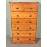 A modern tallboy pine chest of drawers