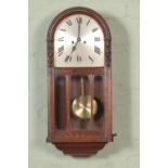 A H.A.C (Hamberg American Clock Co) wall clock with roman numeral dial.