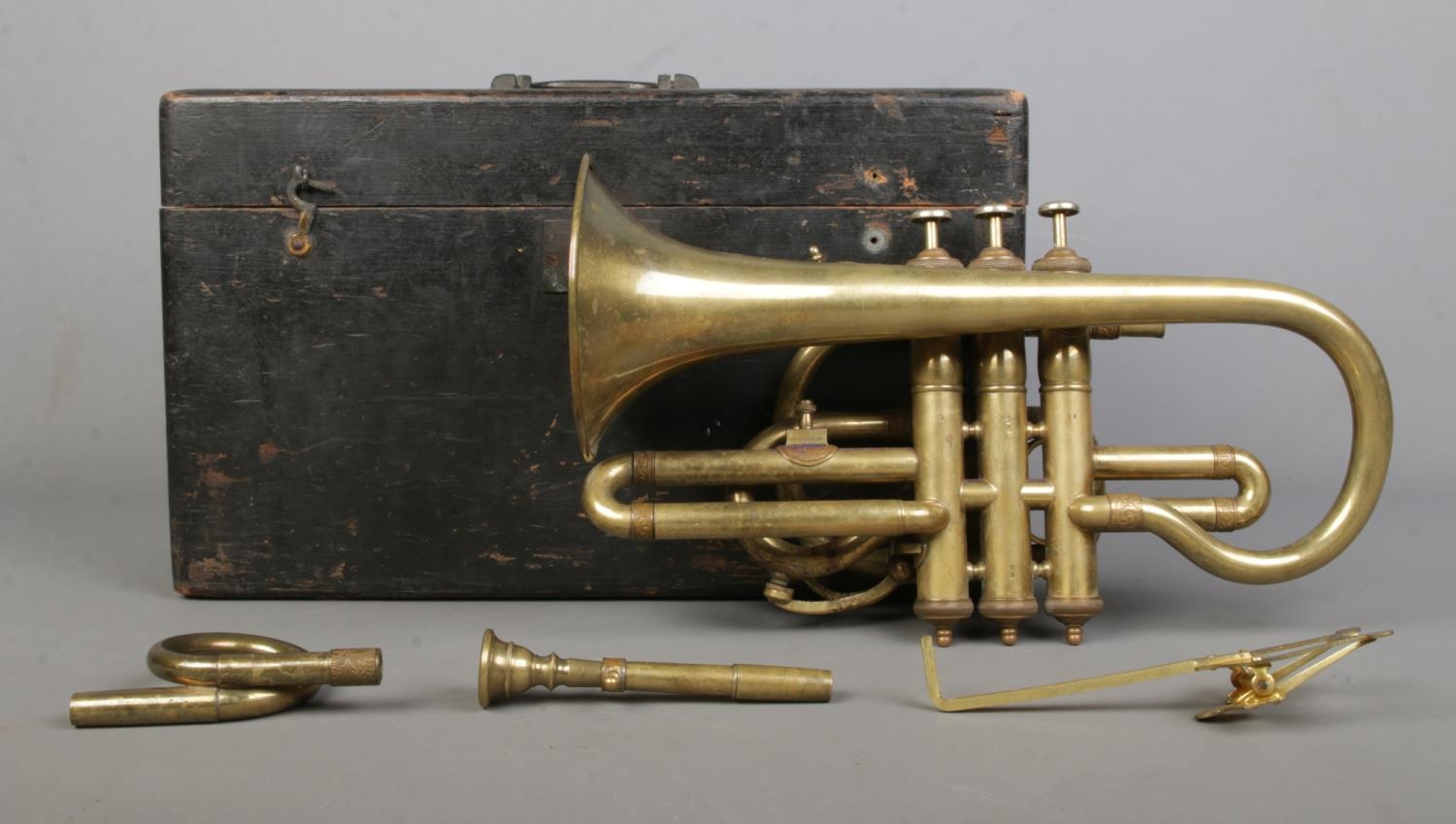 A Leroy Paris brass plated pocket trumpet, in case. Some attachments missing from case. Keys are