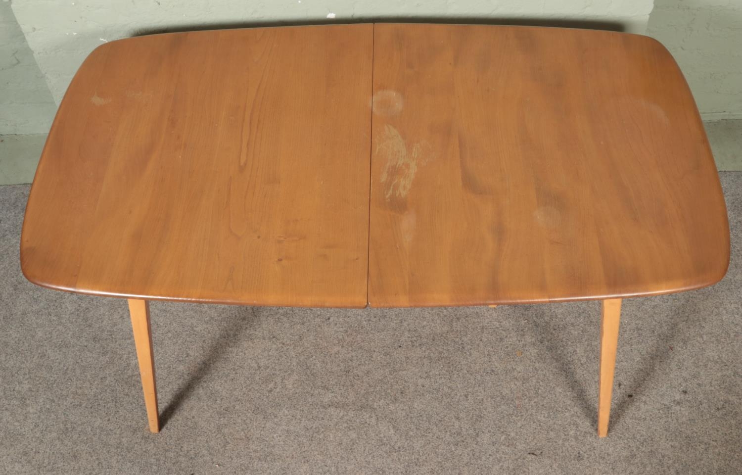 An Ercol 'Grand Windsor' light oak and ash extending dining table, with hinged additional leaf, - Image 3 of 7