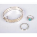 A small collection of silver jewellery to include floral engraved bangle and two rings. Total weight