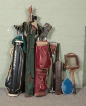 A quantity of vintage sporting equipment, to include golf clubs, fishing rods, shooting stick and