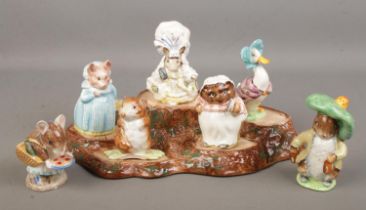 A set of seven Beswick Beatrix Potter figures with Beswick tree stump stand. Some of the figures