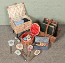 A collection of sewing equipment together with a selection of gardening books in a basket and