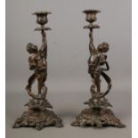 A pair of late 19th century French bronze candlesticks by F. Souchal, Paris. the stems having