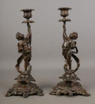 A pair of late 19th century French bronze candlesticks by F. Souchal, Paris. the stems having