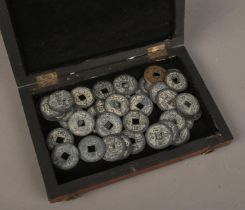 An antique rosewood box with collection of Chinese coins/tokens.