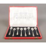 A cased set of eight 'British Hallmarks' silver teaspoons with rat tail bowls. Four pairs of