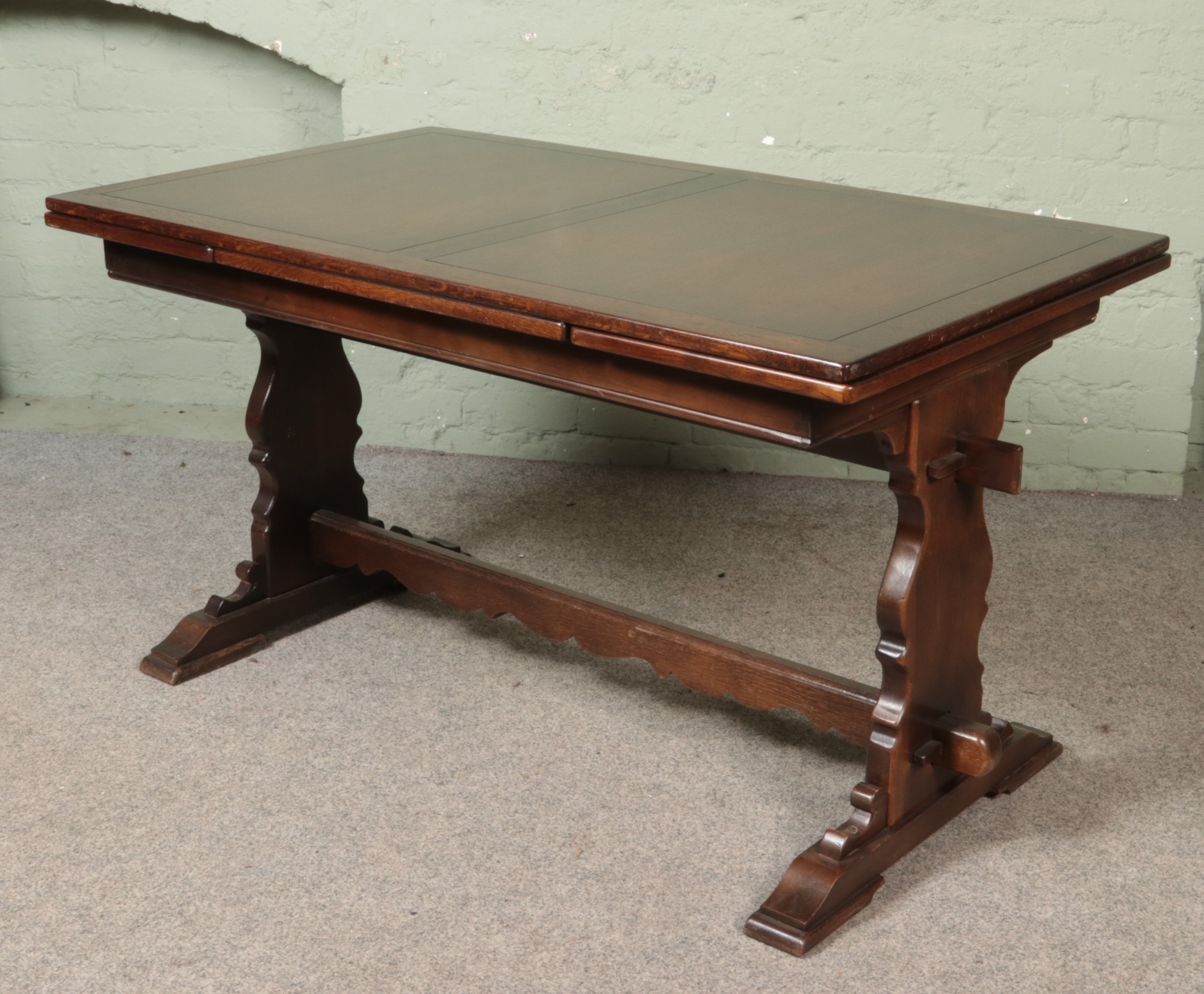 A oak refectory table with six leather upholstered chairs