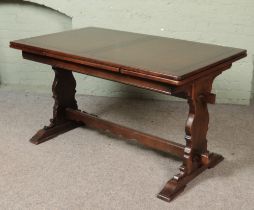 A oak refectory table with six leather upholstered chairs