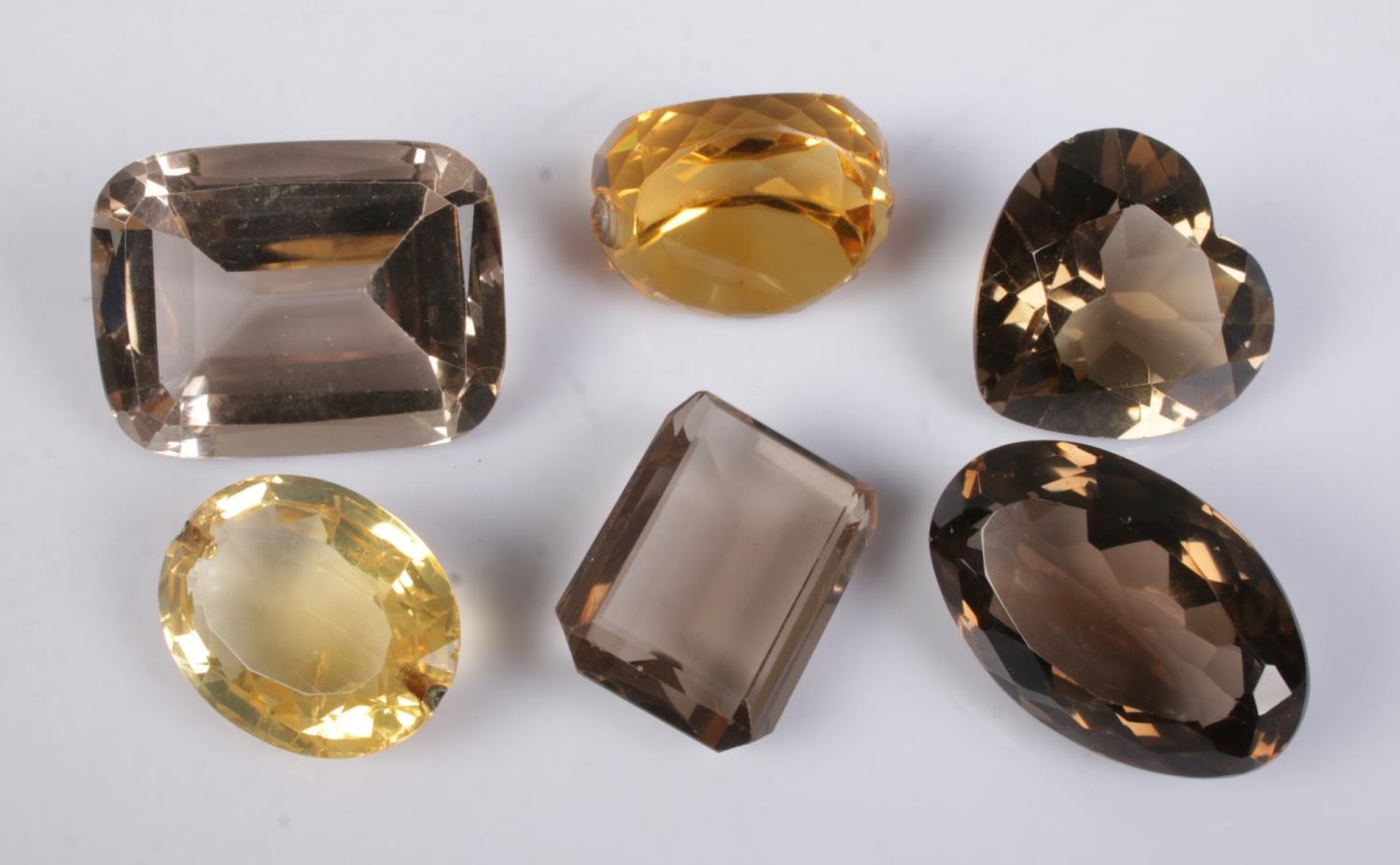 A collection of loose cut Smokey Quartz and Citrine stones to include heart shaped example.