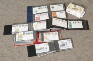 A box containing a large quantity of first day covers including an album of Falkland War covers.