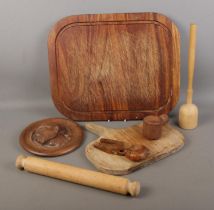 A collection of treen to include chopping boards, carved nutcracker, portrait relief, etc.
