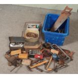 A box and a basket of tools. Includes vice, spanners, Primus stove, hand saws etc.