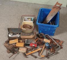 A box and a basket of tools. Includes vice, spanners, Primus stove, hand saws etc.