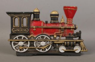 A painted cast iron doorstop in the form of a steam train. 26cm long.