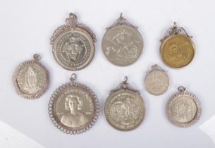A collection of silver mounted commemorative coins to include Bicentenary of the Derby crown,
