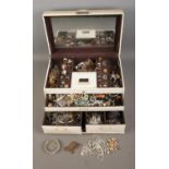 A vintage jewellery box with contents of assorted costume jewellery to include bracelets,