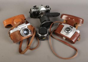 A Wrayflex 35mm SLR camera along with Agfa and Yashica FX-D examples. Lens clouded on Wrayflex.