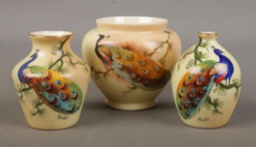 Three small Locke & Co Worcester vases. All hand painted and decorated with a peacock. Signed H