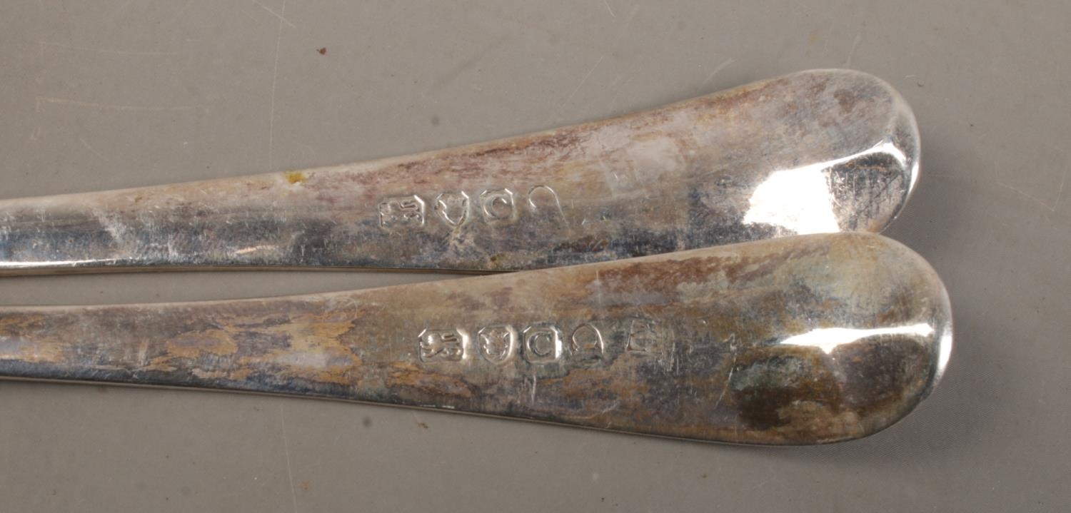A pair of late Eighteenth Century Georgian table spoons, with floral detailing and 'E' engraved to - Image 2 of 2