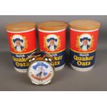 A collection of Quaker Oats collectables including three containers and an alarm clock